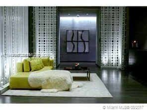 a living room with furniture and floor to ceiling windows