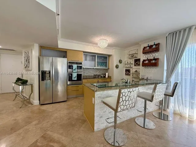a kitchen with a refrigerator and cabinets