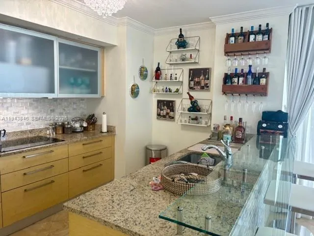 a kitchen with stainless steel appliances granite countertop a stove top oven a sink a counter space and cabinets