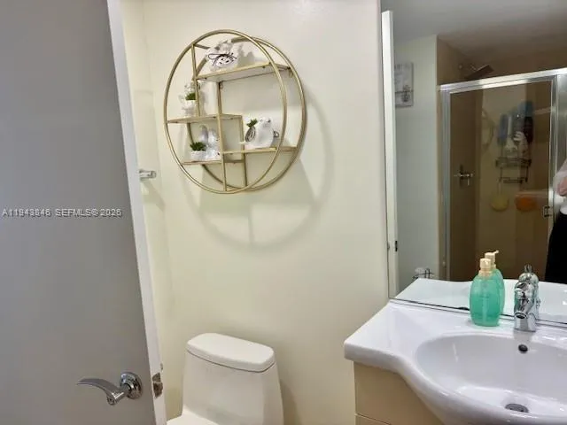 a bedroom with a bed and painting on the wall