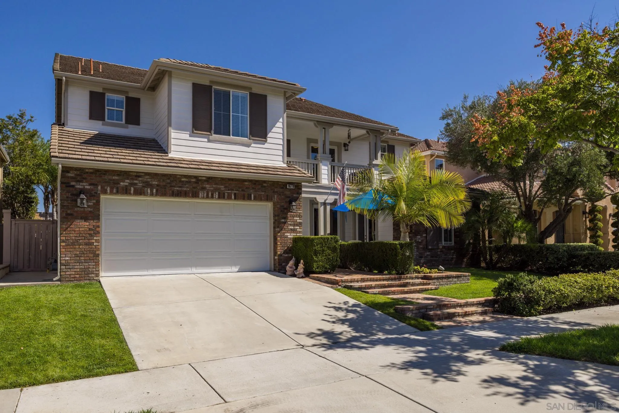 16778 Deer Ridge Road San Diego, CA 92127 - Photo 1 of 54 a front view of a house with a yard and garage