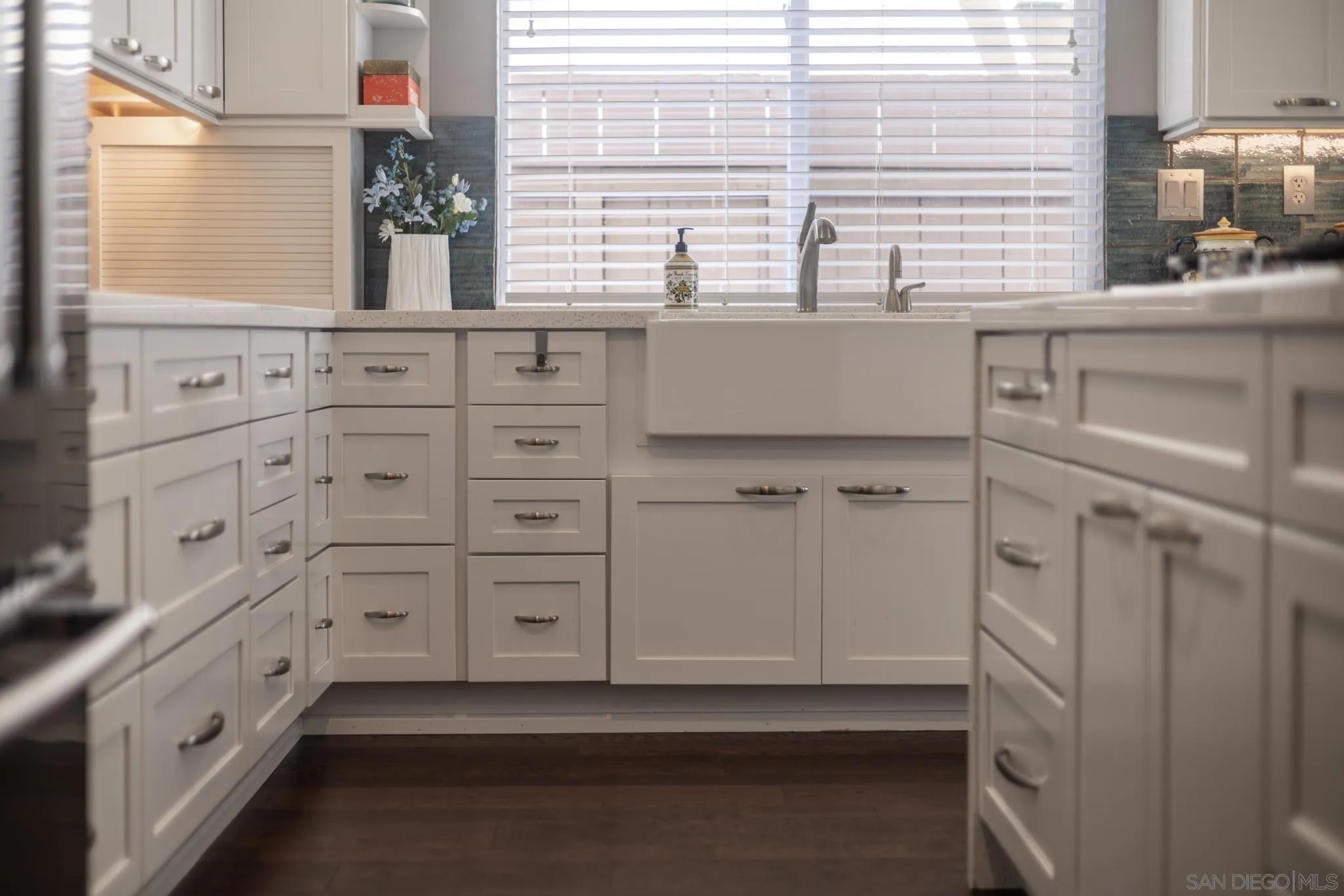 16778 Deer Ridge Road San Diego, CA 92127 - Photo 13 of 54 a kitchen with white cabinets and a window