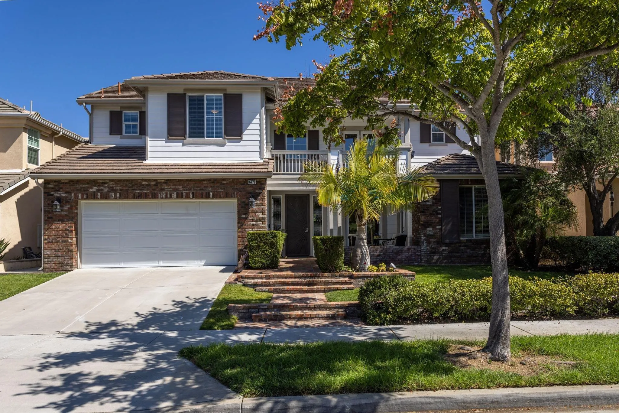16778 Deer Ridge Road San Diego, CA 92127 - Photo 2 of 54 a front view of a house with garden