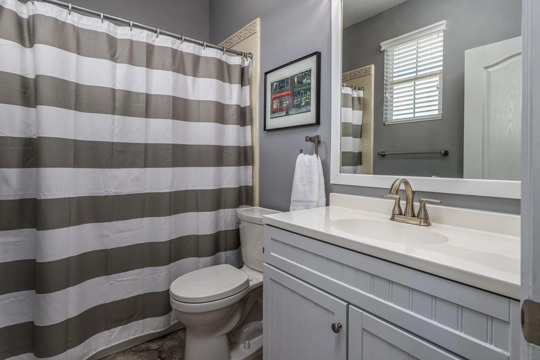 16778 Deer Ridge Road San Diego, CA 92127 - Photo 33 of 54 a bathroom with a sink a toilet a mirror and shower curtain