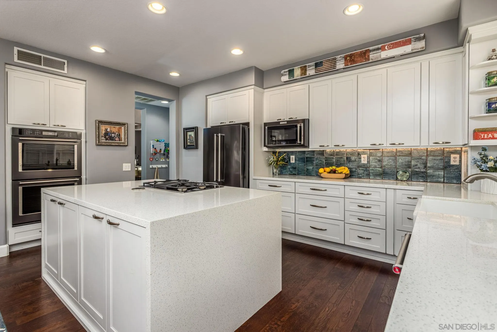 16778 Deer Ridge Road San Diego, CA 92127 - Photo 5 of 54 a kitchen with white cabinets and stainless steel appliances