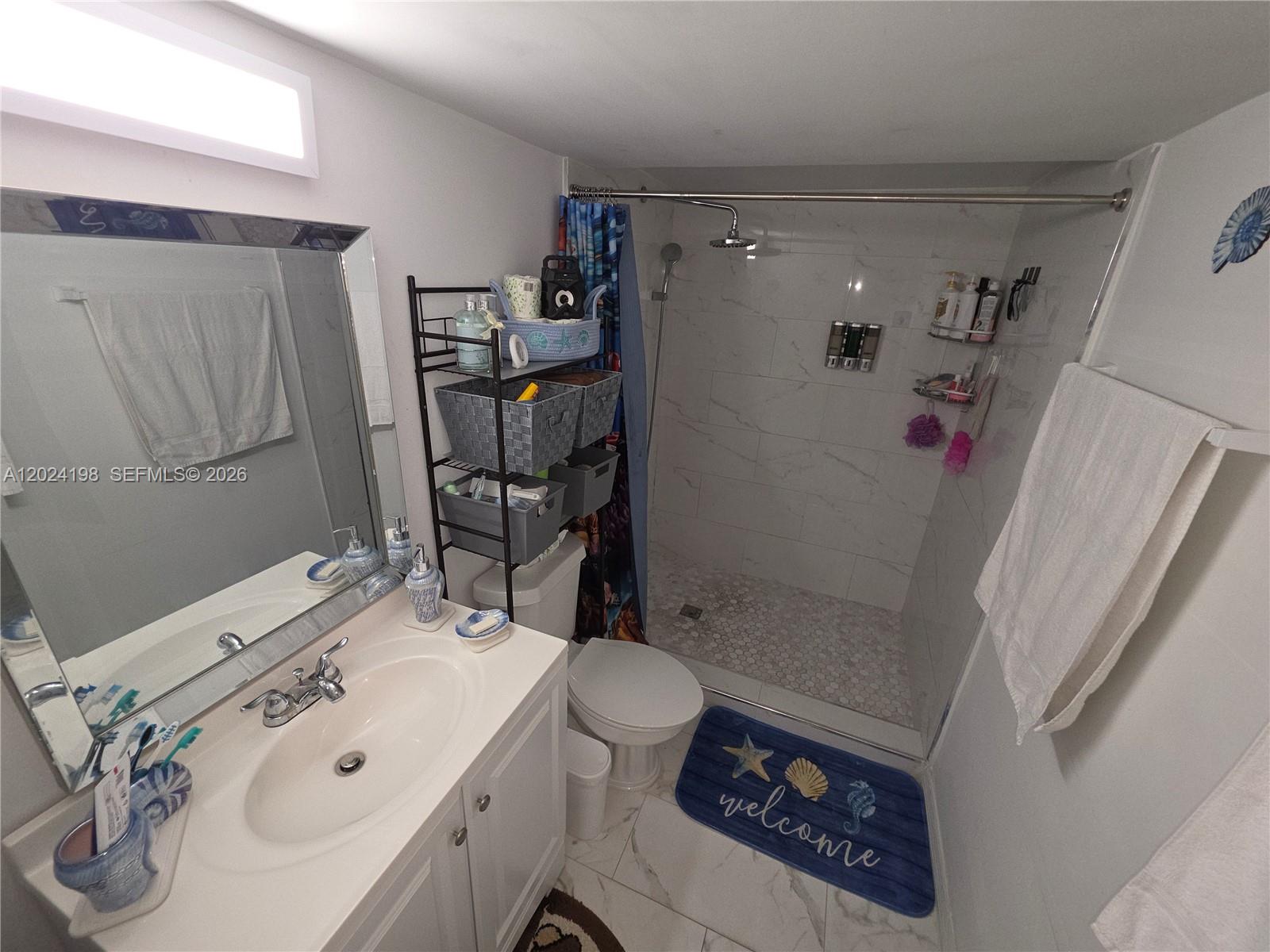 651 East 48th Street Hialeah, FL 33013 - Photo 11 of 52 a bathroom with a sink a toilet and shower