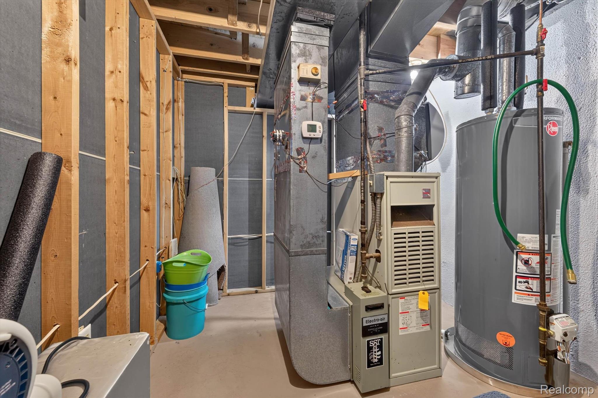 46362 Springhill Drive Utica, MI 48317 - Photo 39 of 59 Basement utility area featuring a hot water heater, furnace, and exposed ductwork