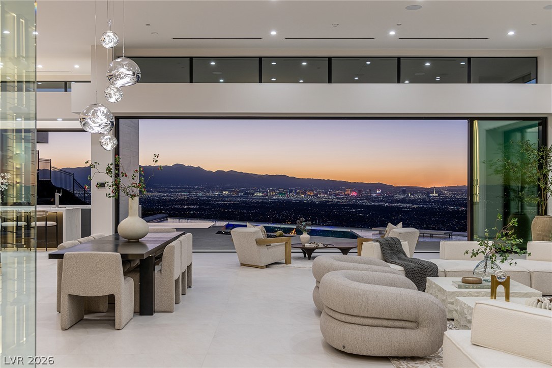 563 Grand Rim Drive Henderson, NV 89012 - Photo 70 of 70 An open floorplan living space offers captivating city and mountain views through wide sliding glass doors.
