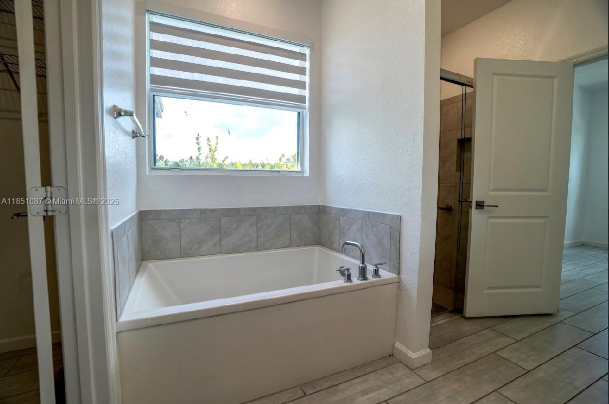 30600 Southwest 193rd Avenue Homestead, FL 33030 - Photo 21 of 36 a white bath tub sitting next to a window