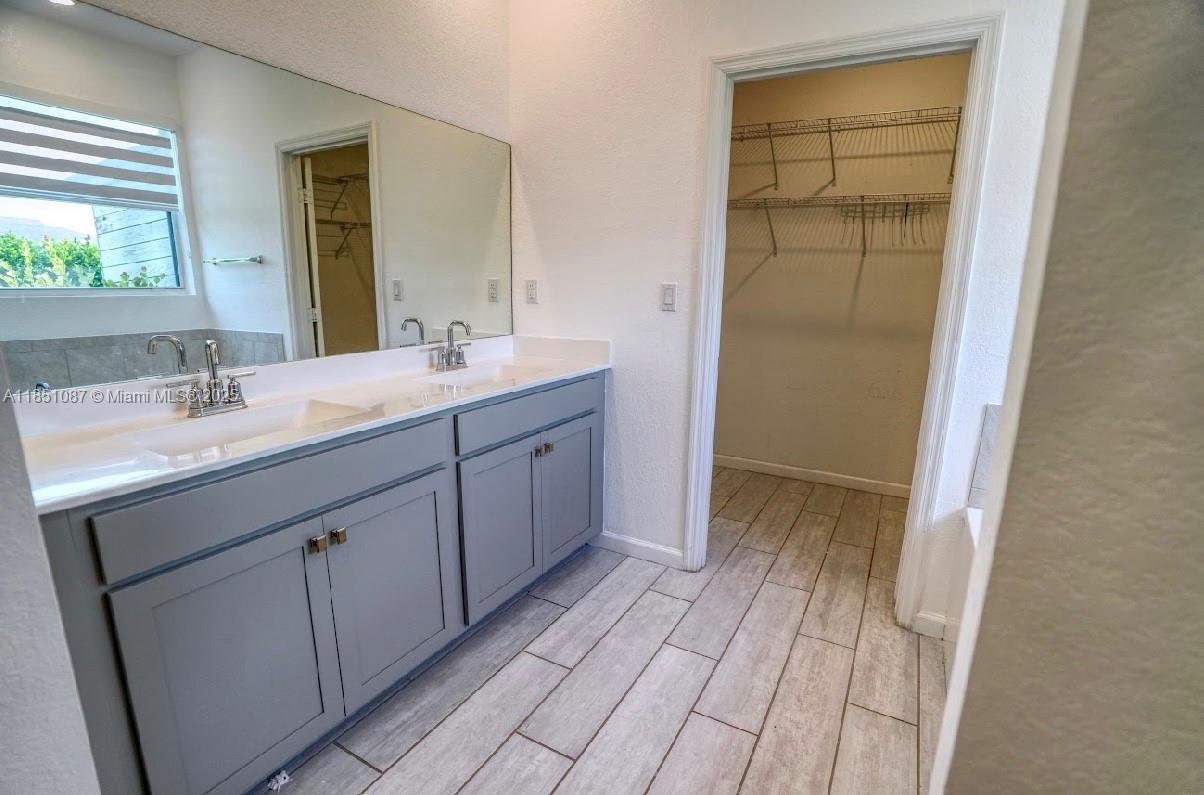 30600 Southwest 193rd Avenue Homestead, FL 33030 - Photo 22 of 36 a spacious bathroom with a double vanity sink and a mirror