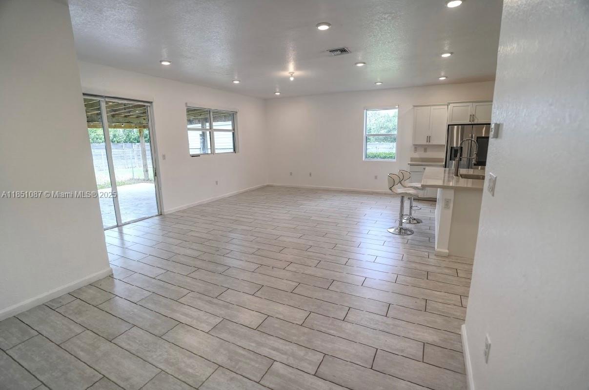 30600 Southwest 193rd Avenue Homestead, FL 33030 - Photo 30 of 36 an empty room with wooden floor and windows
