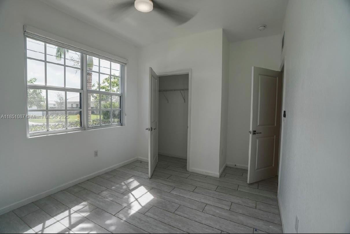 30600 Southwest 193rd Avenue Homestead, FL 33030 - Photo 8 of 36 a view of a room with wooden floor and window