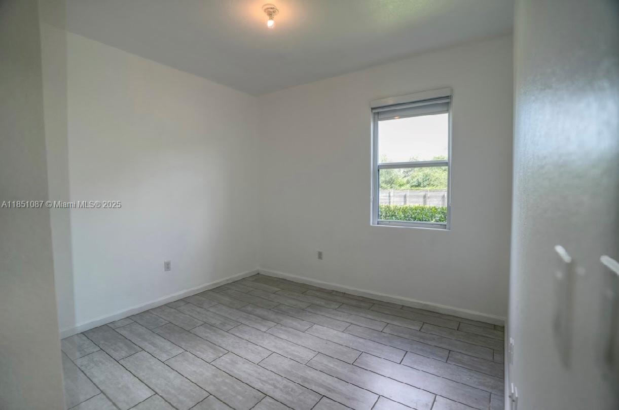 30600 Southwest 193rd Avenue Homestead, FL 33030 - Photo 9 of 36 an empty room with a window