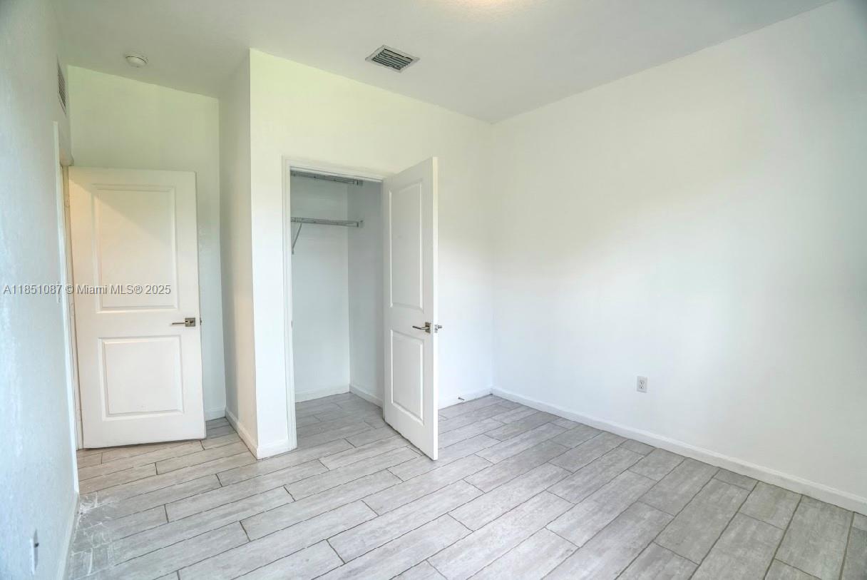 30600 Southwest 193rd Avenue Homestead, FL 33030 - Photo 10 of 36 wooden floor in an empty room