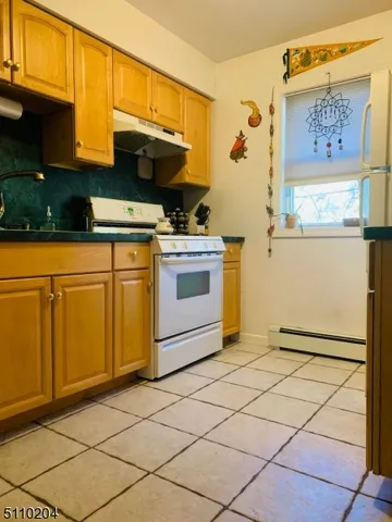 a kitchen with a stove top oven and cabinets