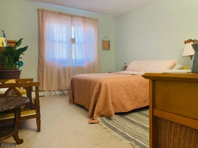 a bedroom with a bed and a table in it