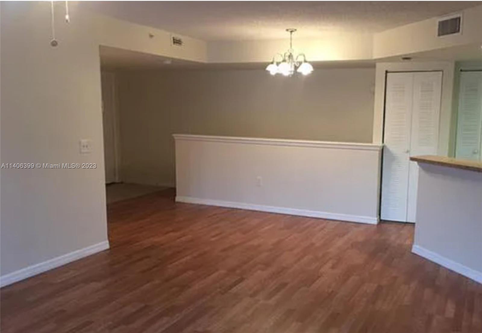 4155 Haverhill Road, Unit 1418 West Palm Beach, FL 33417 - Photo 12 of 13 a view of a livingroom with wooden floor