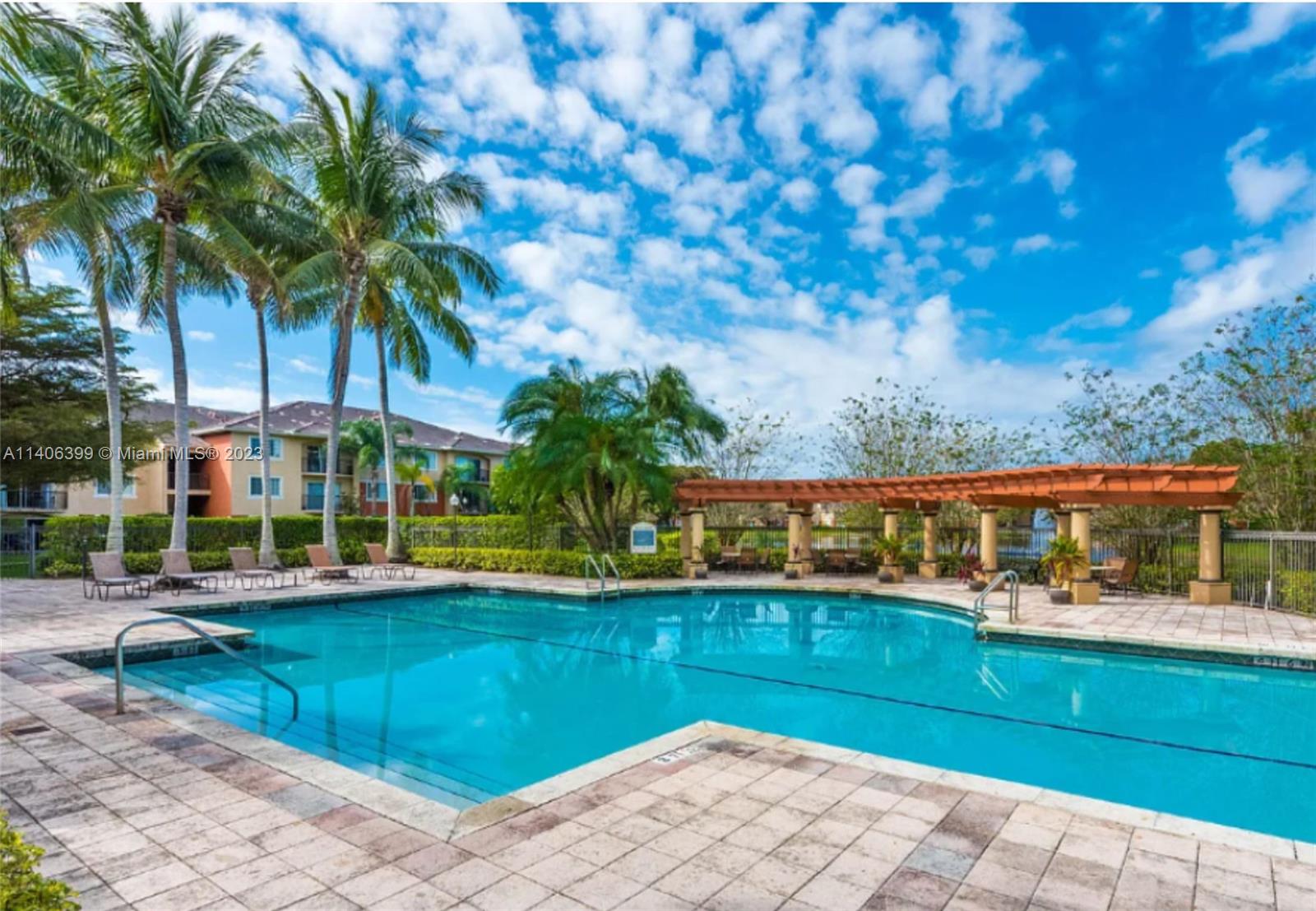 4155 Haverhill Road, Unit 1418 West Palm Beach, FL 33417 - Photo 2 of 13 a view of a swimming pool with an outdoor seating