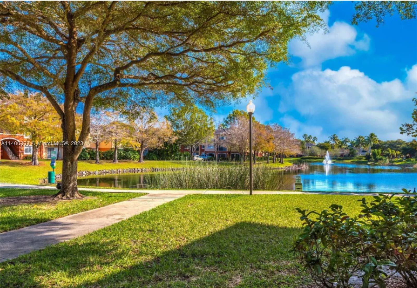 4155 Haverhill Road, Unit 1418 West Palm Beach, FL 33417 - Photo 4 of 13 a view of yard with swimming pool and green space