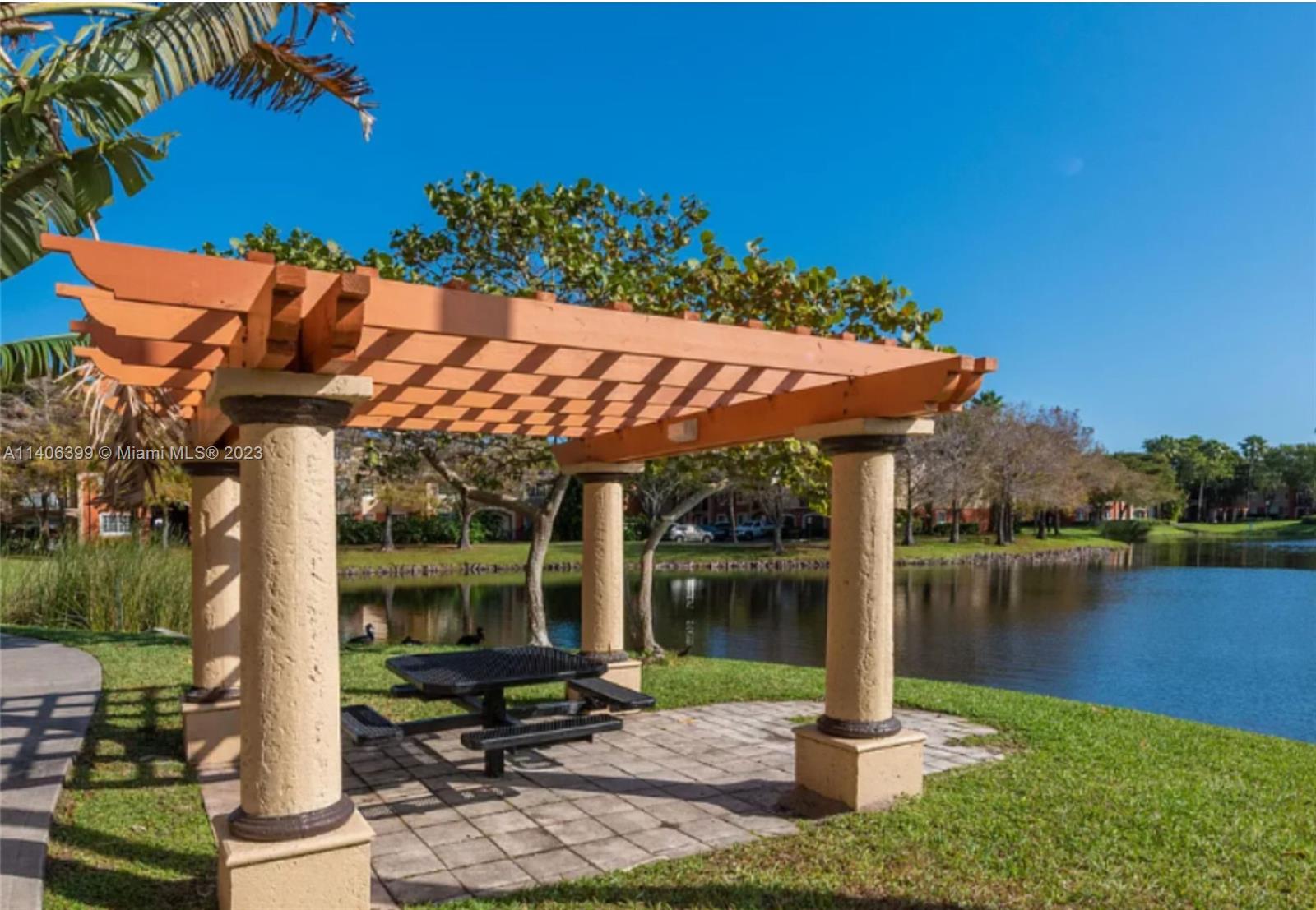 4155 Haverhill Road, Unit 1418 West Palm Beach, FL 33417 - Photo 5 of 13 a patio with water view fountain and a patio