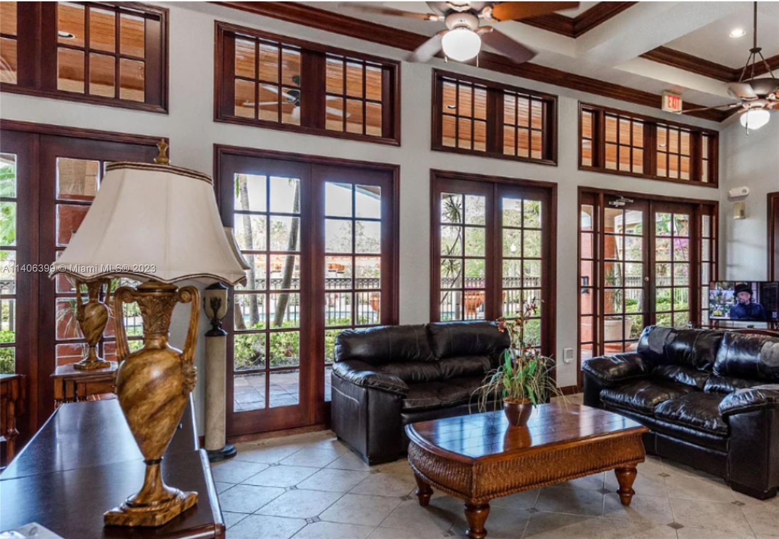 4155 Haverhill Road, Unit 1418 West Palm Beach, FL 33417 - Photo 6 of 13 a living room with furniture and a floor to ceiling window