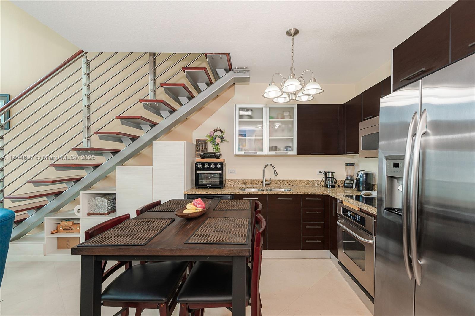 41 Southeast 5th Street, Unit 1503 Miami, FL 33131 - Photo 16 of 27 a kitchen with cabinets a sink stainless steel appliances and cabinets
