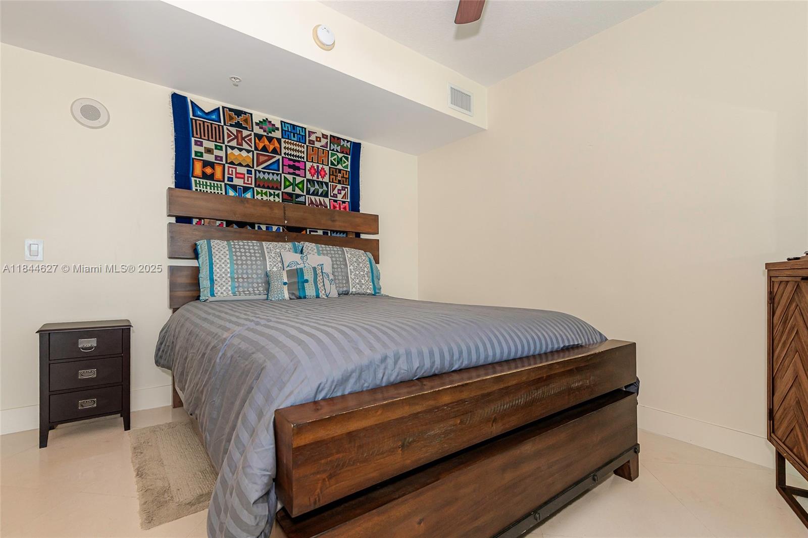 41 Southeast 5th Street, Unit 1503 Miami, FL 33131 - Photo 20 of 27 a bedroom with a bed and dresser