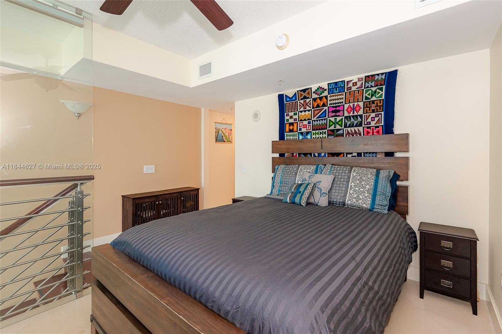 41 Southeast 5th Street, Unit 1503 Miami, FL 33131 - Photo 21 of 27 a bedroom with a bed and a dresser