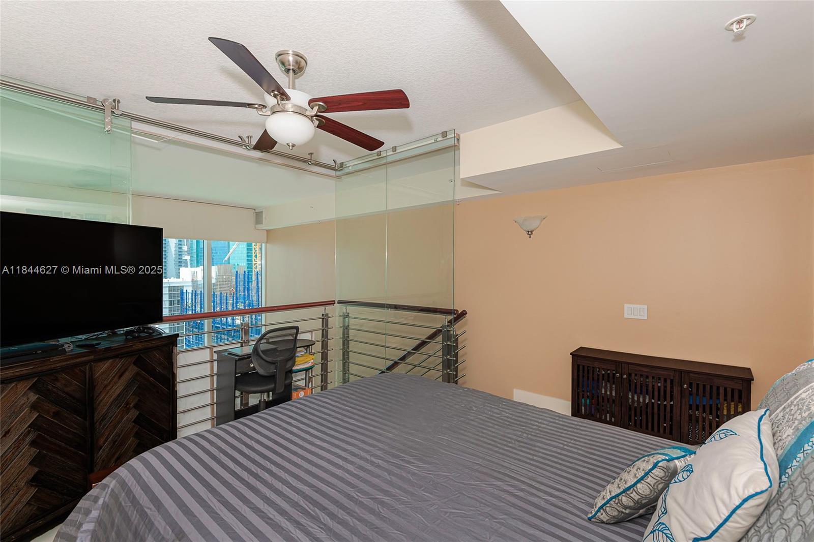 41 Southeast 5th Street, Unit 1503 Miami, FL 33131 - Photo 22 of 27 a bedroom with a bed and a flat screen tv