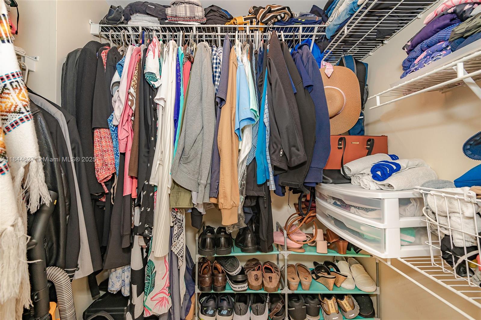 41 Southeast 5th Street, Unit 1503 Miami, FL 33131 - Photo 24 of 27 a view of walk in closet with clothes and shoes