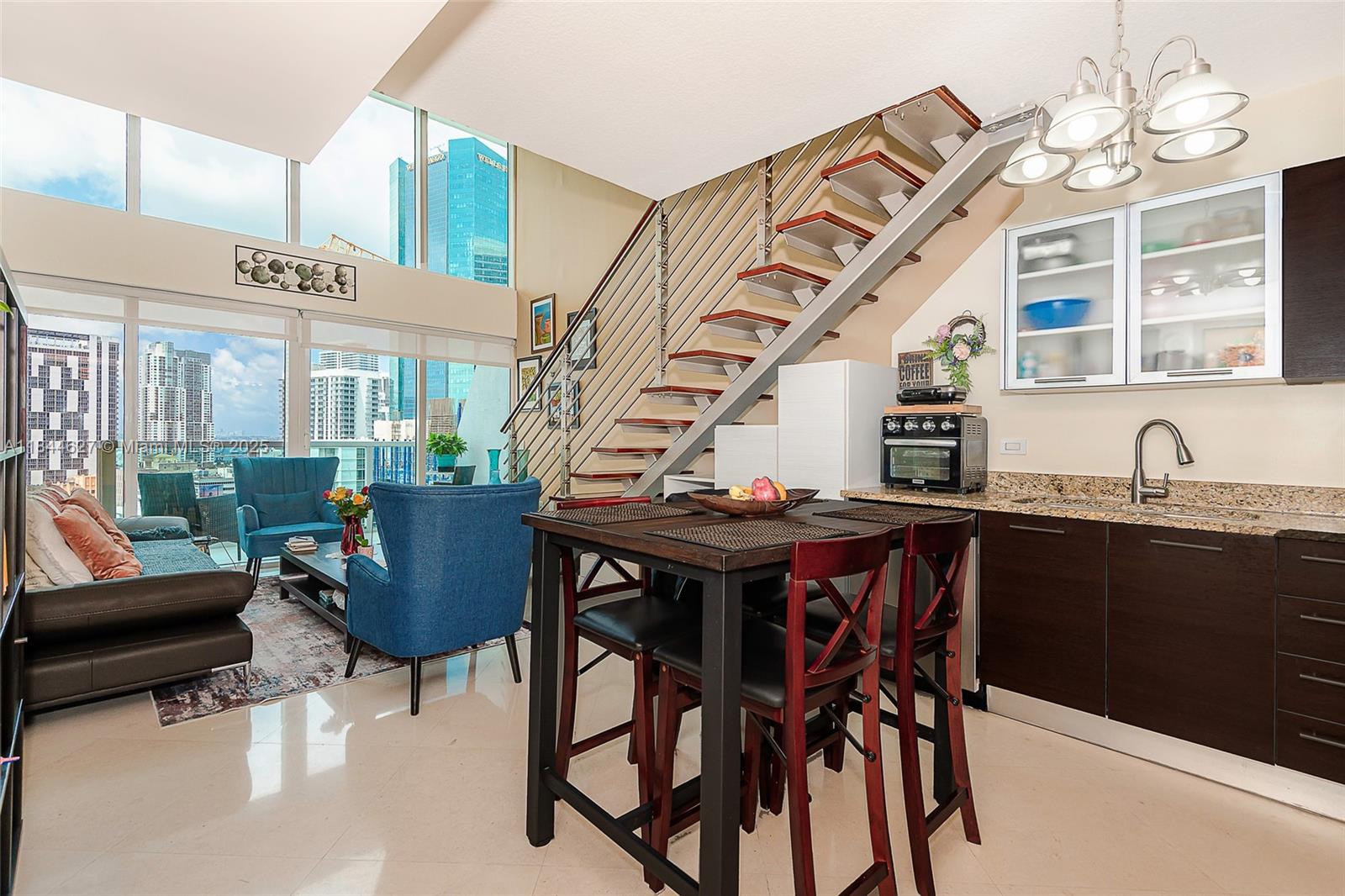 41 Southeast 5th Street, Unit 1503 Miami, FL 33131 - Photo 7 of 27 a view of a dining room with furniture and a chandelier