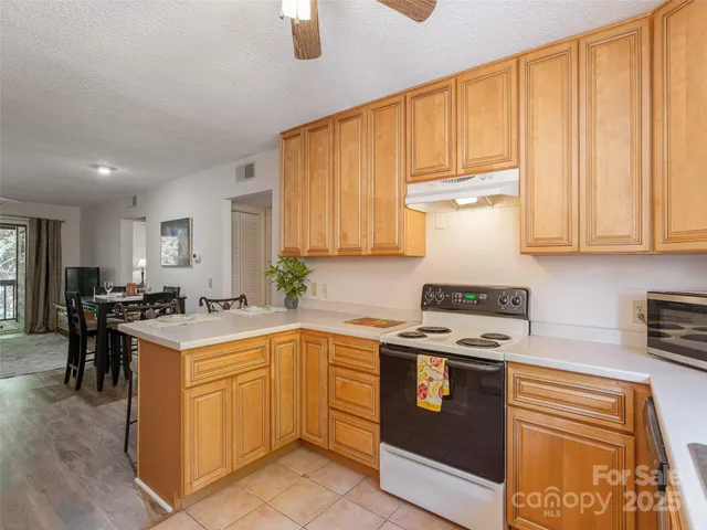 a kitchen with a stove a sink and a refrigerator