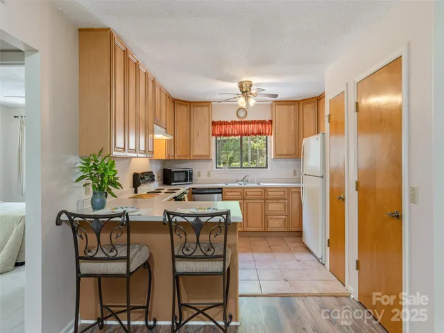 a kitchen with a table and chairs in it