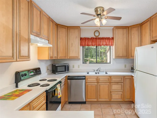 a kitchen with a stove a sink and a refrigerator