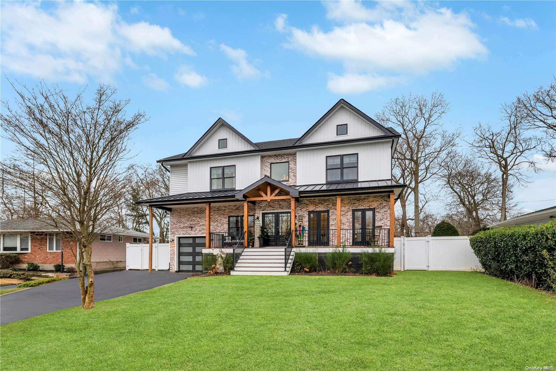 6 Evon Lane St. James, NY 11780 - Photo 1 of 1 a front view of a house with a garden and yard