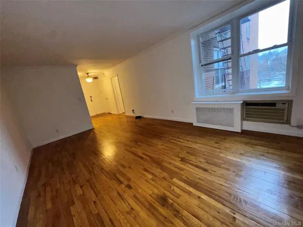 wooden floor in an empty room with a window