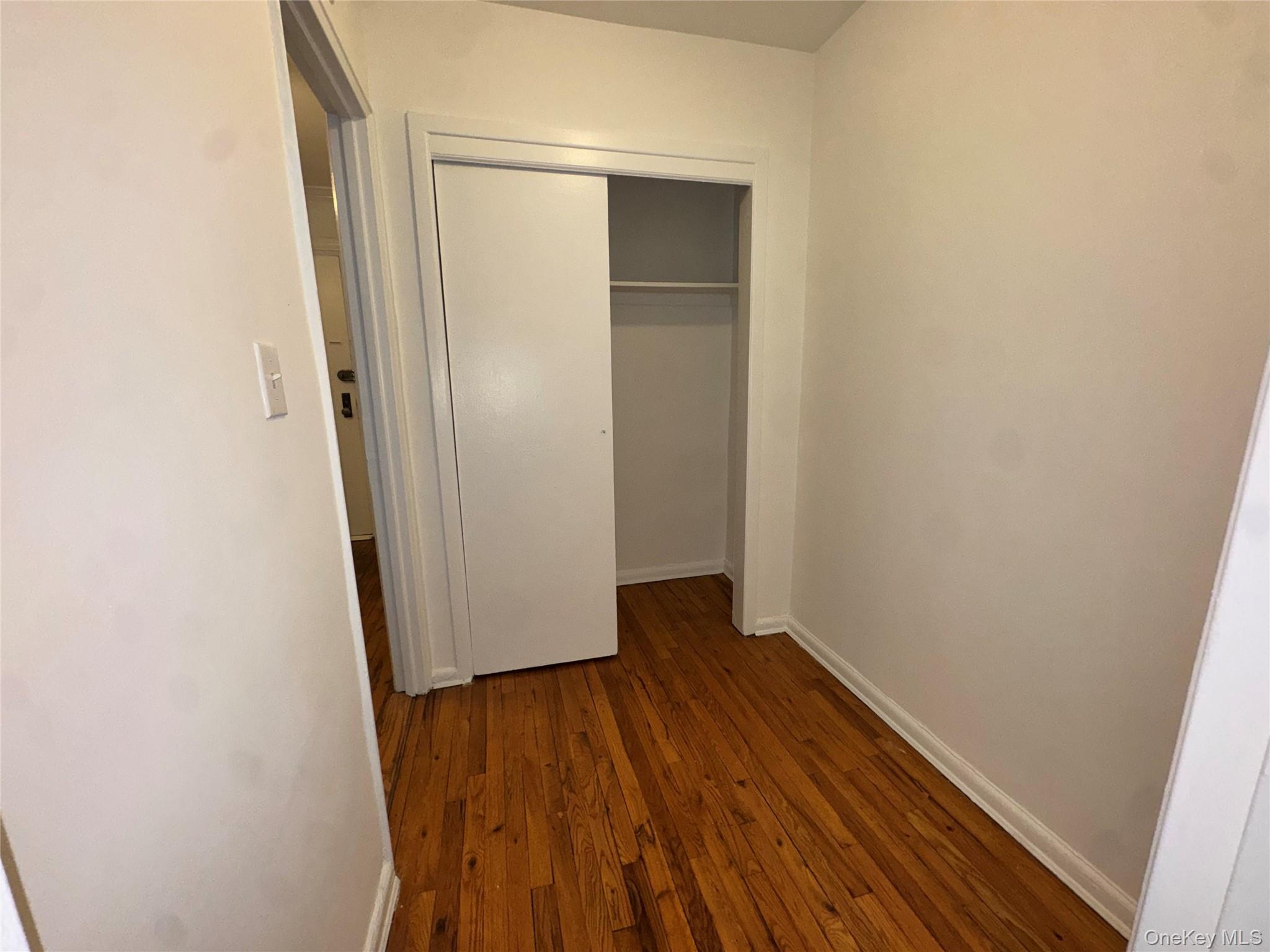 43 Bronx River Road, Unit 6C Yonkers, NY 10704 - Photo 4 of 12 an empty room with wooden floor and entrance