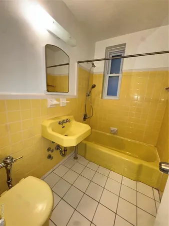 a bathroom with a sink mirror toilet and shower