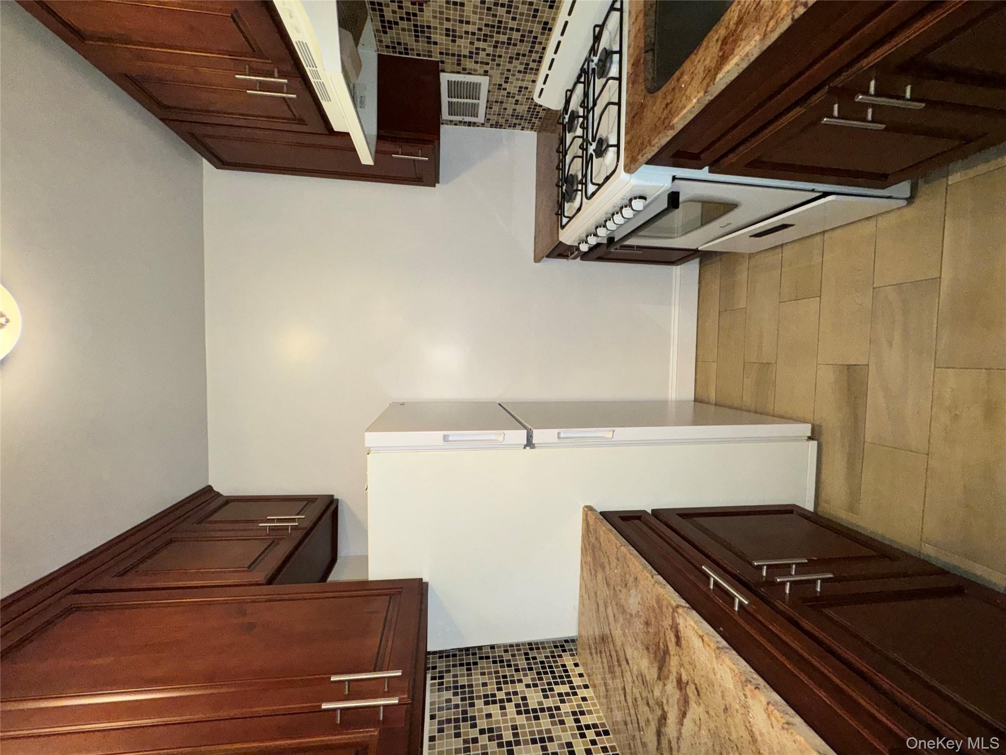 43 Bronx River Road, Unit 6C Yonkers, NY 10704 - Photo 7 of 12 a kitchen with stainless steel appliances granite countertop a stove a refrigerator and a sink