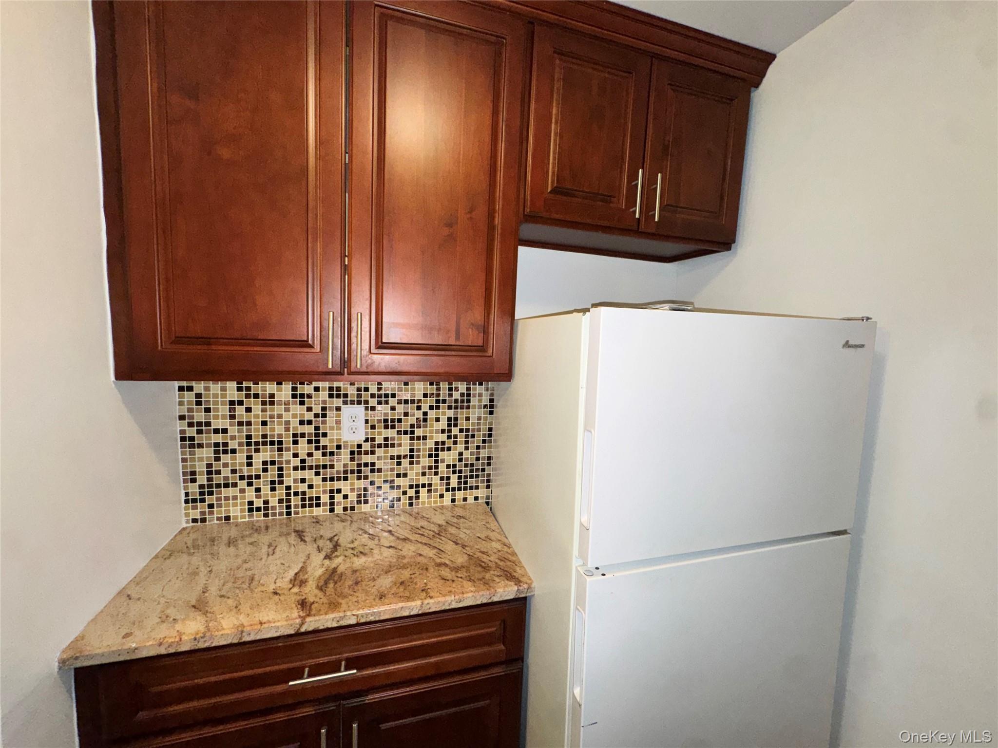 43 Bronx River Road, Unit 6C Yonkers, NY 10704 - Photo 9 of 12 a white refrigerator freezer sitting in a kitchen