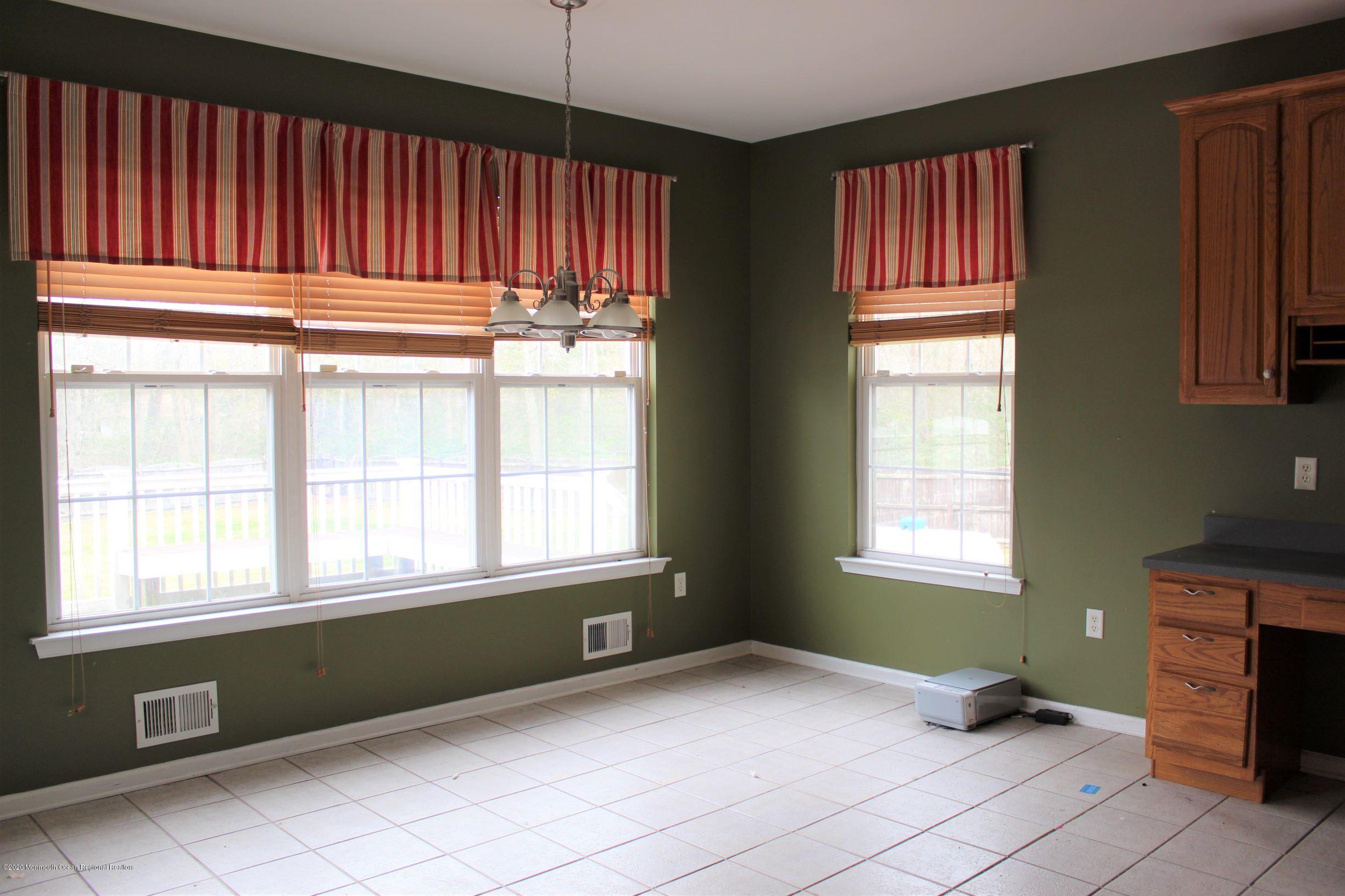 211 Cassville Road Jackson, NJ 08527 - Photo 13 of 58 a view of an empty room with a window and a kitchen