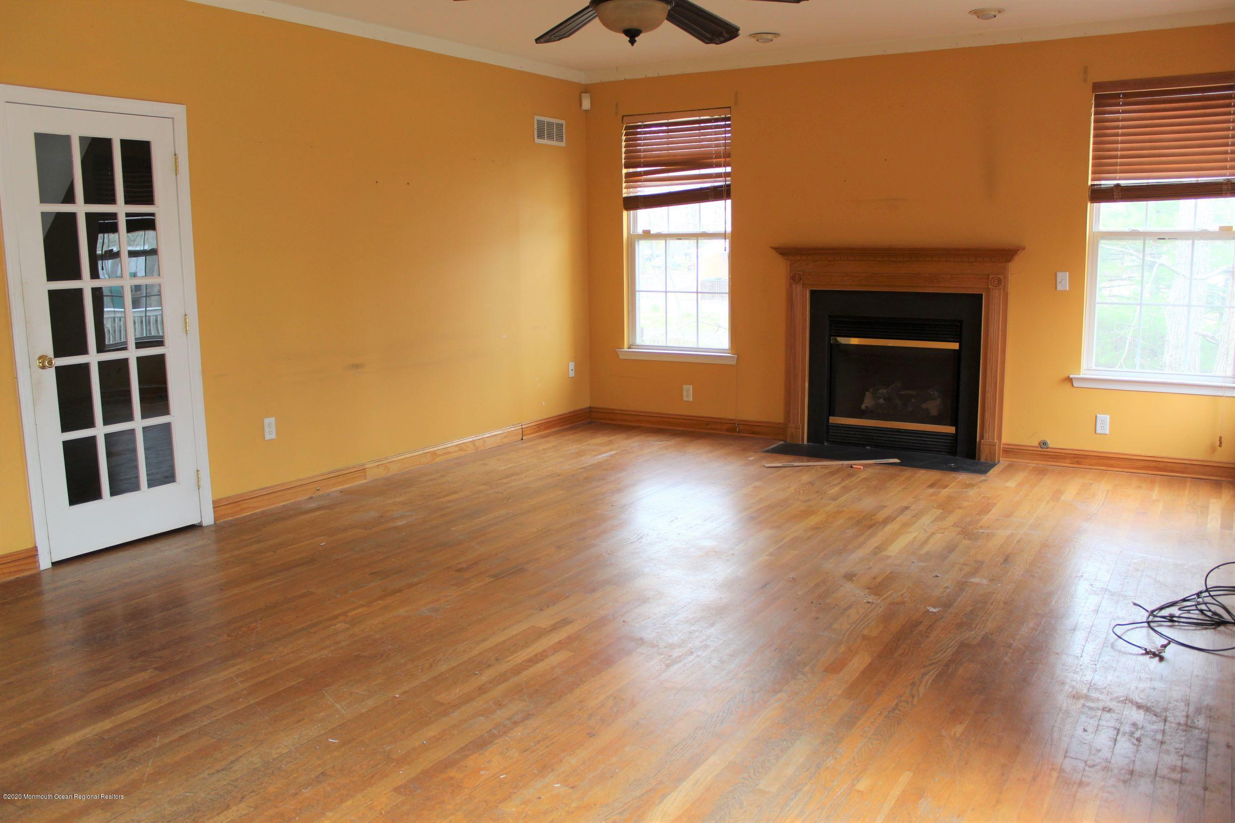211 Cassville Road Jackson, NJ 08527 - Photo 17 of 58 a view of an empty room with a window and wooden floor