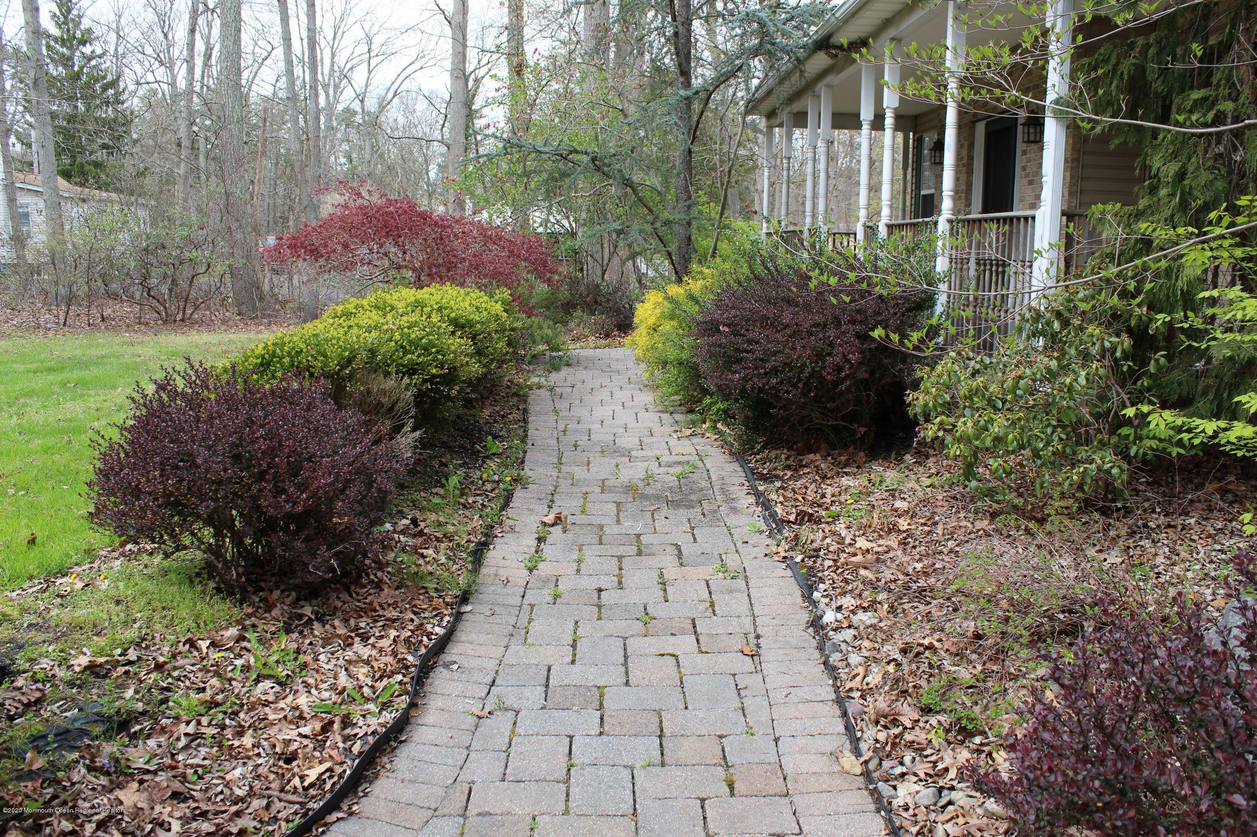 211 Cassville Road Jackson, NJ 08527 - Photo 3 of 58 a view of a pathway with flower plants