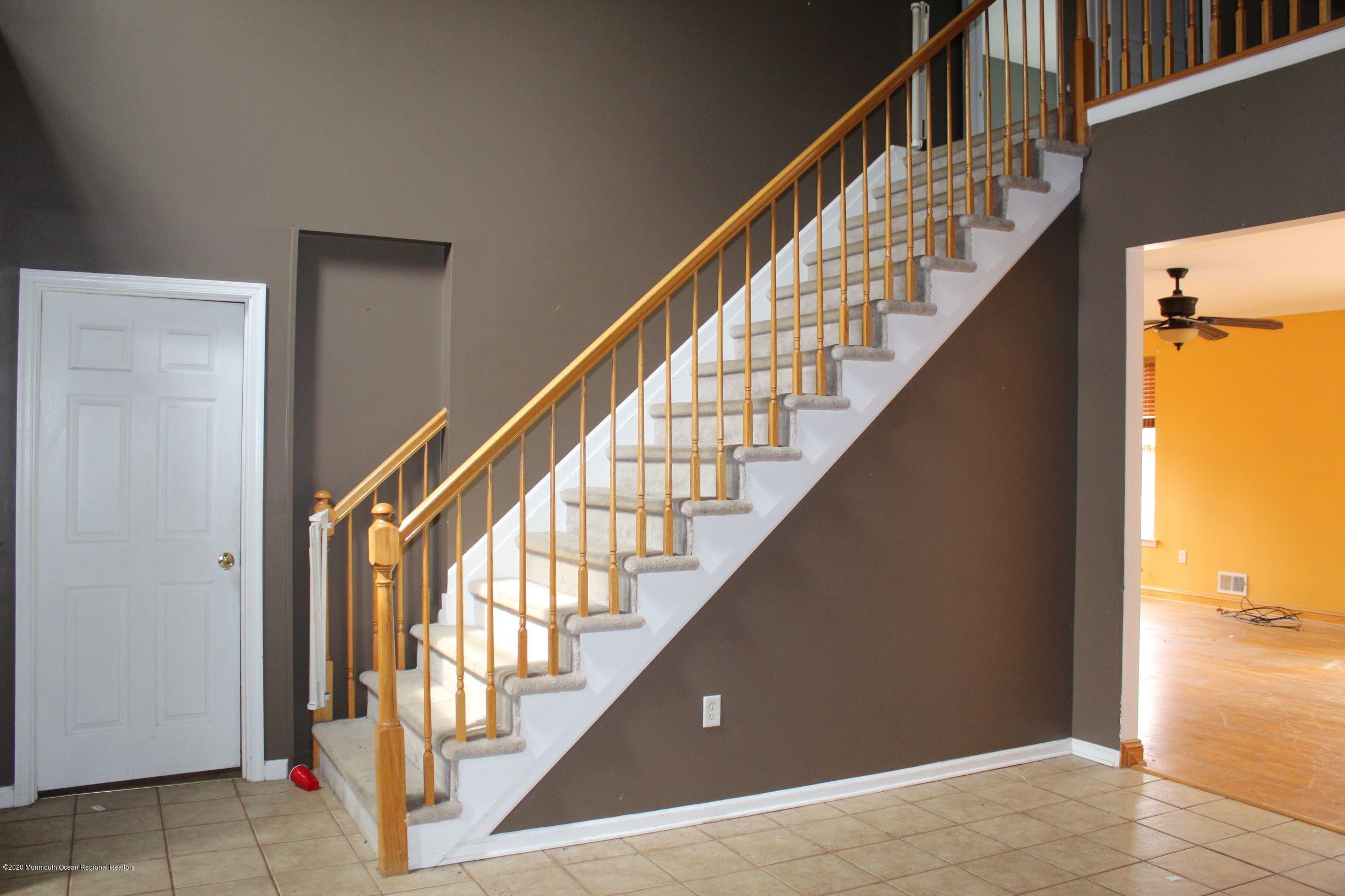211 Cassville Road Jackson, NJ 08527 - Photo 22 of 58 a view of staircase with railing and a chandelier