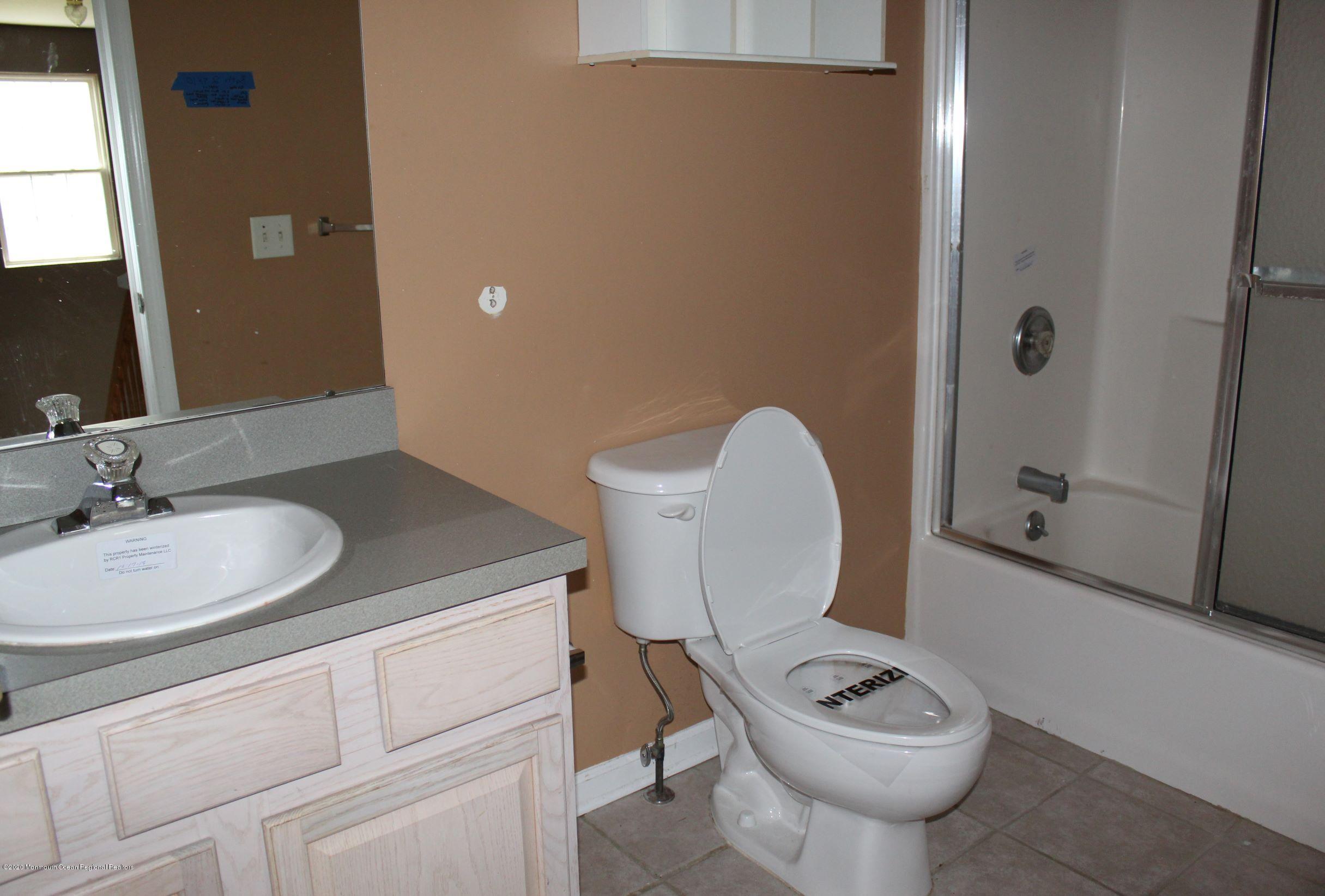 211 Cassville Road Jackson, NJ 08527 - Photo 28 of 58 a bathroom with a granite countertop sink toilet and shower