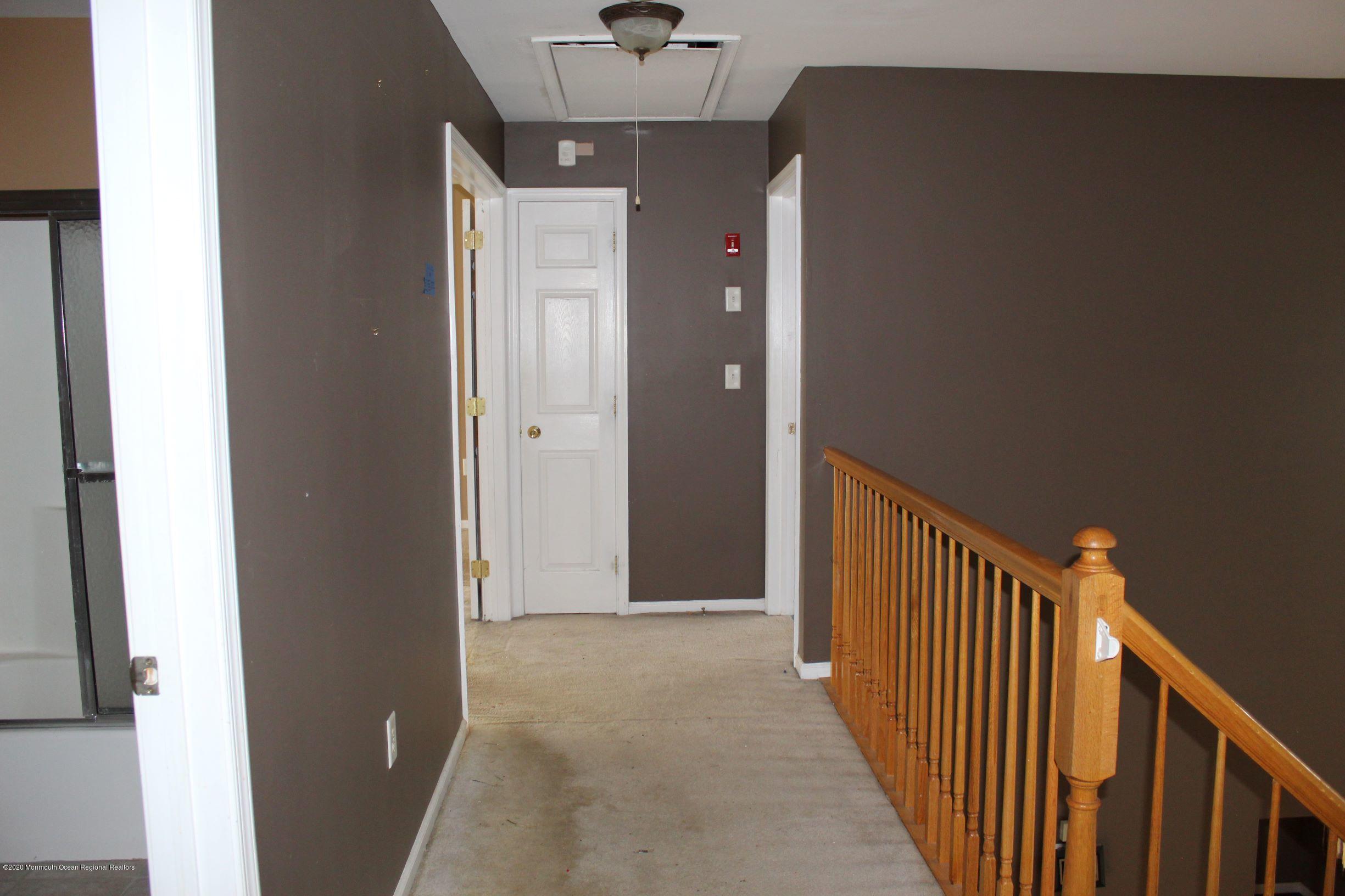 211 Cassville Road Jackson, NJ 08527 - Photo 29 of 58 a view of a hallway with wooden floor