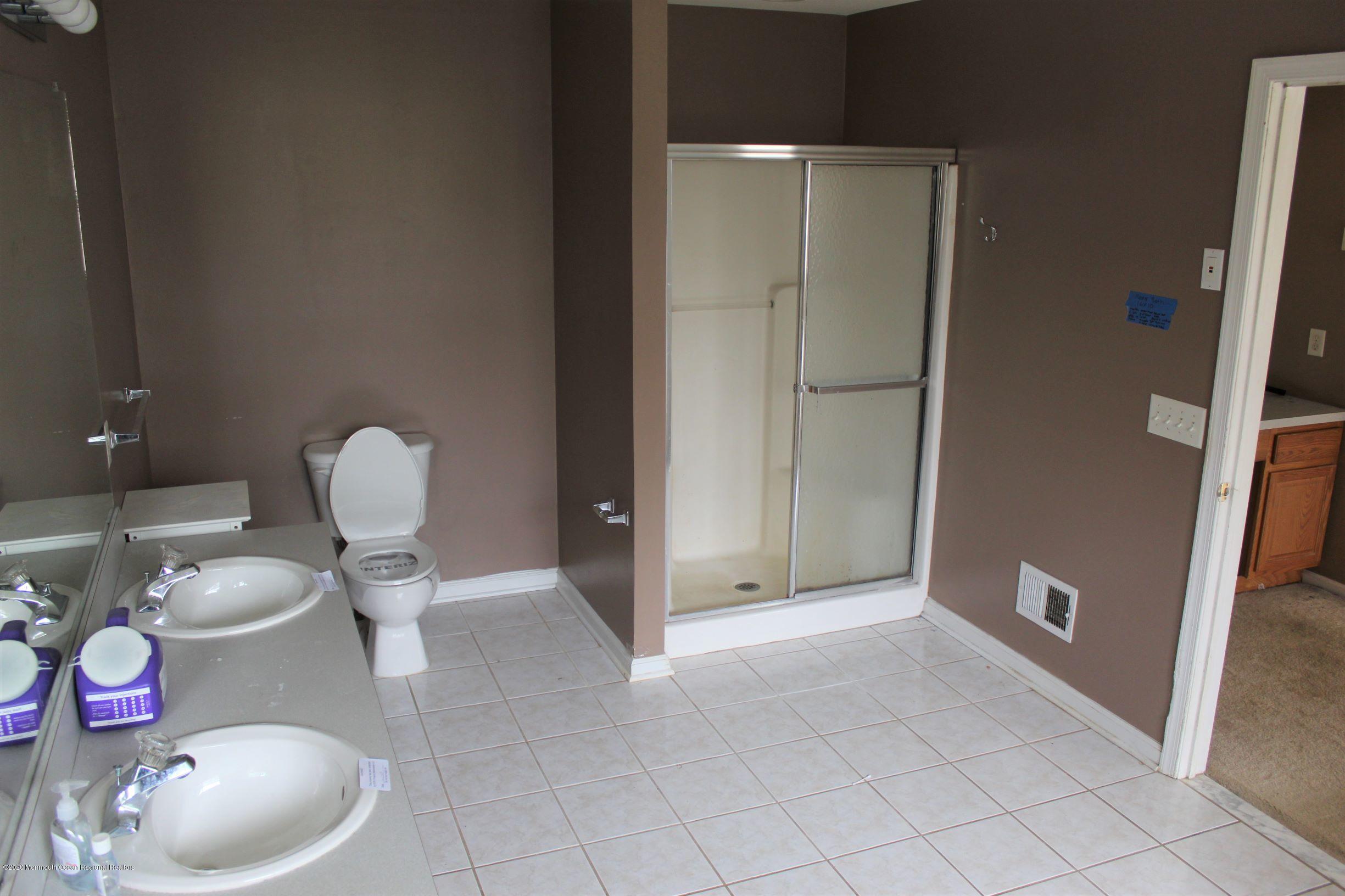 211 Cassville Road Jackson, NJ 08527 - Photo 35 of 58 a bathroom with a granite countertop toilet and a sink