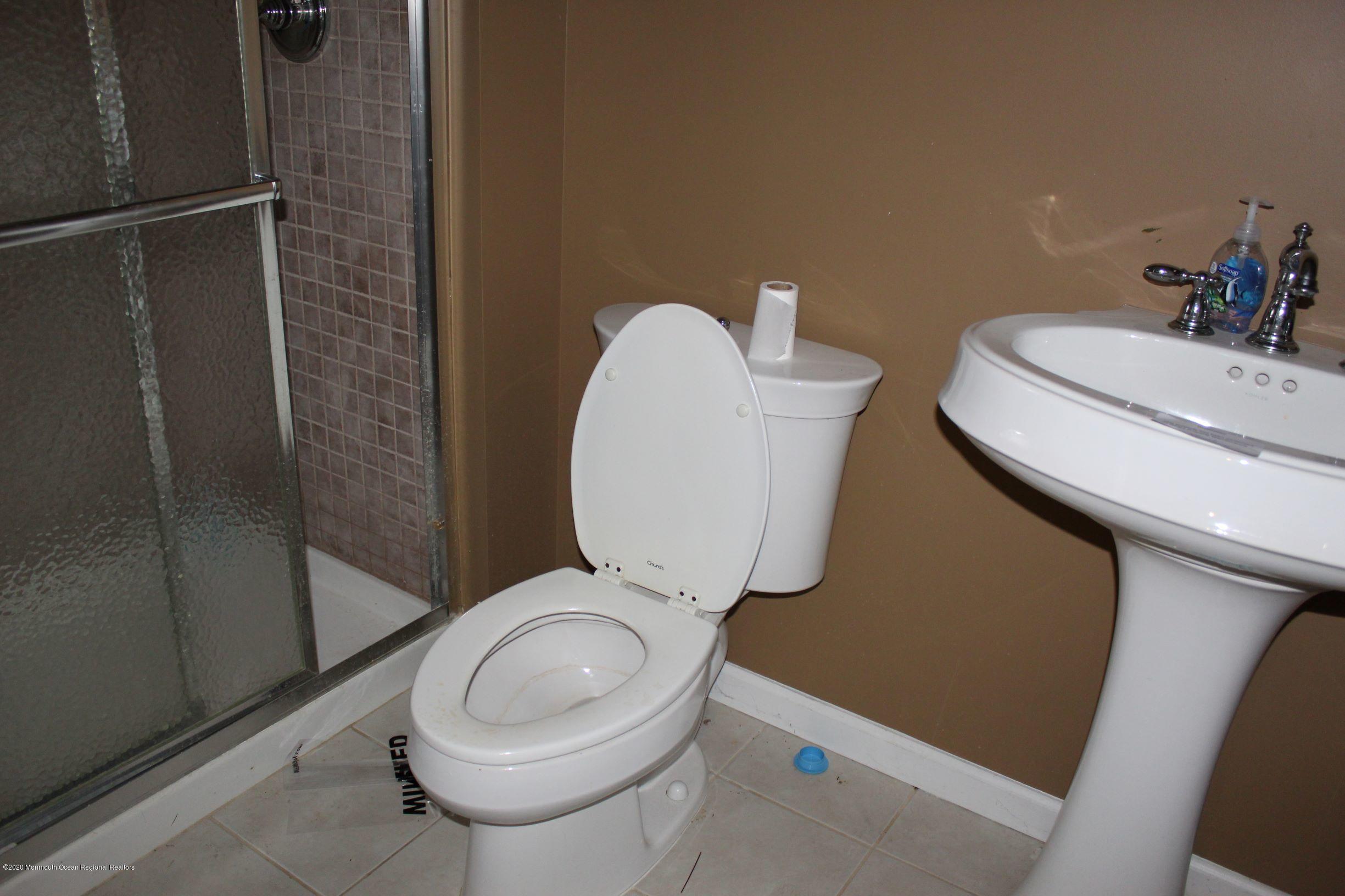 211 Cassville Road Jackson, NJ 08527 - Photo 42 of 58 a bathroom with a toilet and a mirror