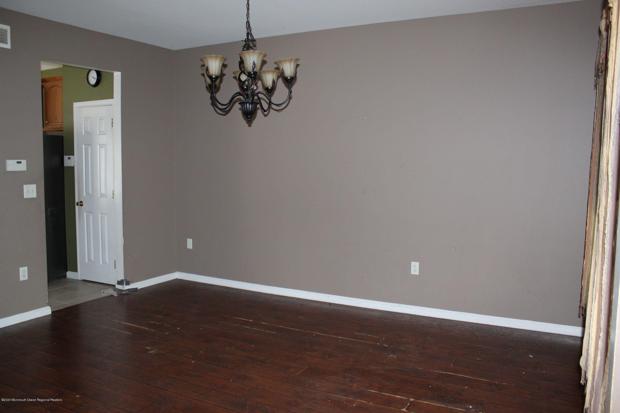 211 Cassville Road Jackson, NJ 08527 - Photo 8 of 58 an empty room with wooden floor and windows
