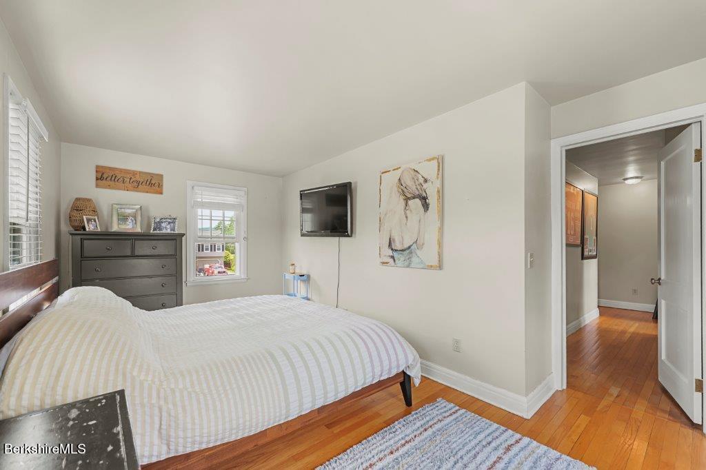 33 Eleanor Road Pittsfield, MA 01201 - Photo 29 of 45 a bedroom with a bed and a flat tv screen on the dresser